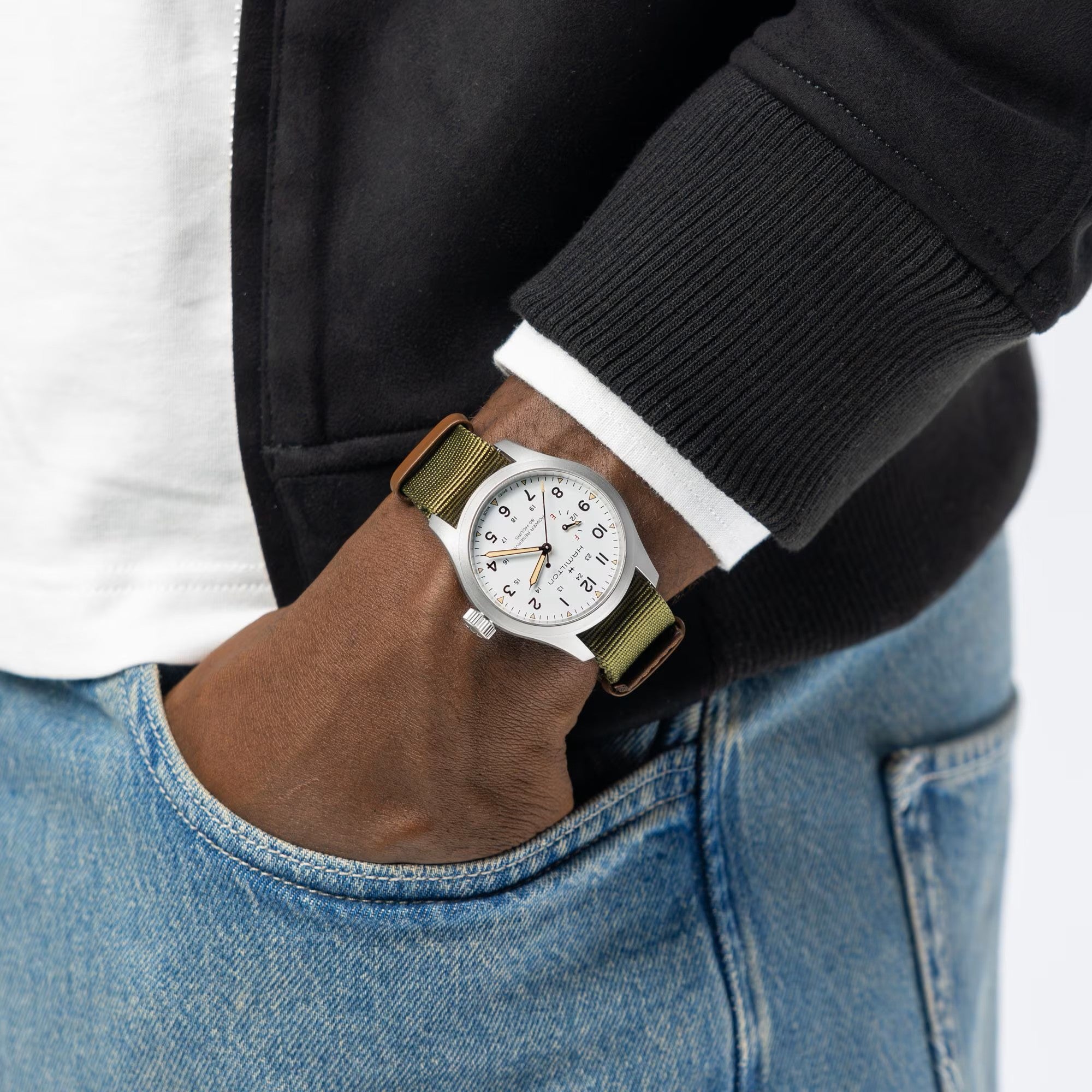 Hamilton Khaki Field Power Reserve watch with white dial and green textile strap on wrist