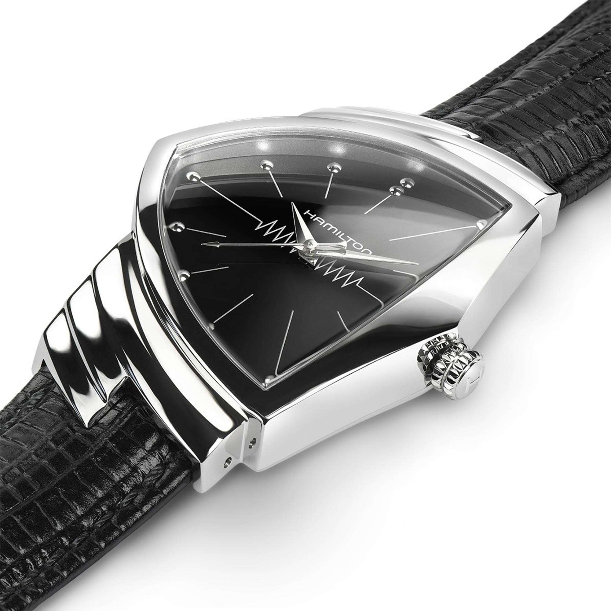 Close-up of a Hamilton Ventura watch with a polished triangular case, black dial, and black leather strap