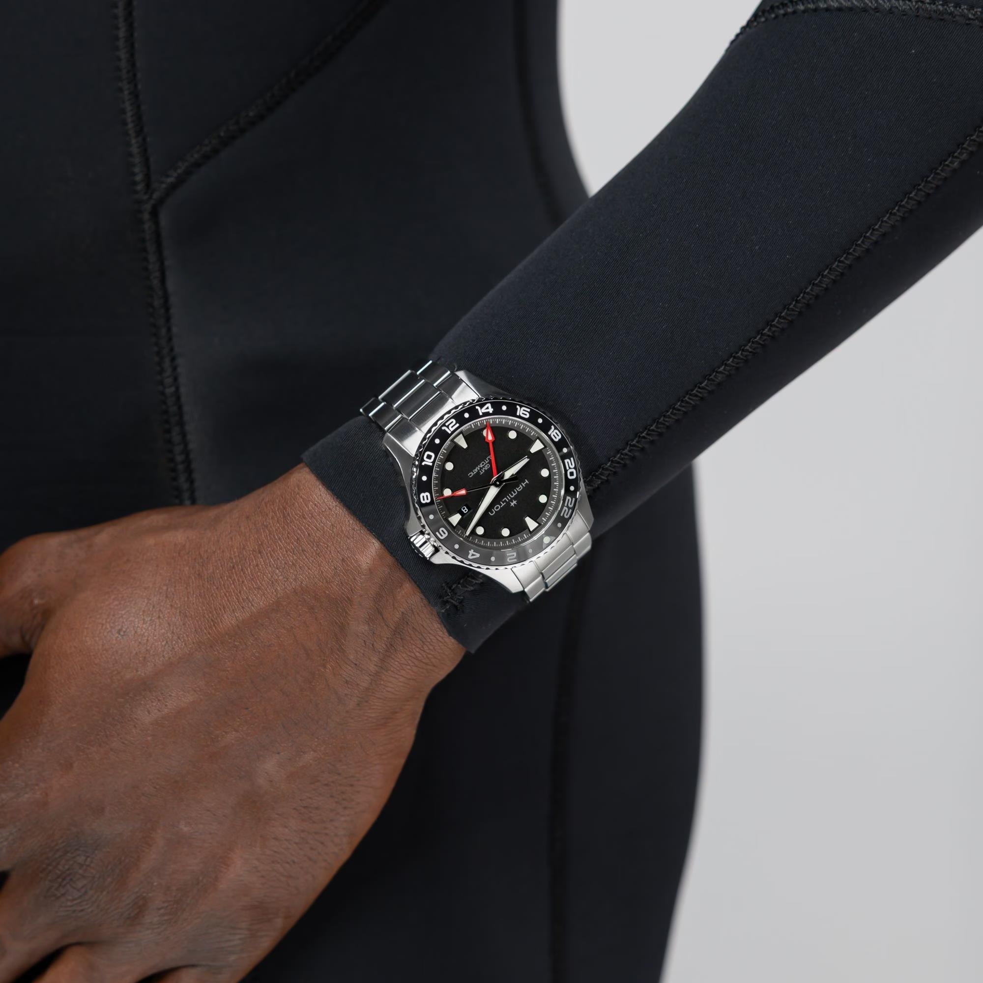 Men's stainless steel scuba watch on wrist, black dial with red seconds hand