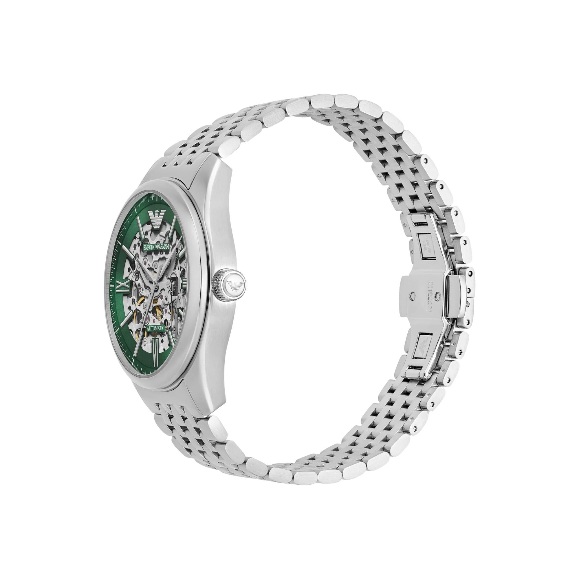 Steel automatic watch with green skeleton dial, curved case and link bracelet, side view.