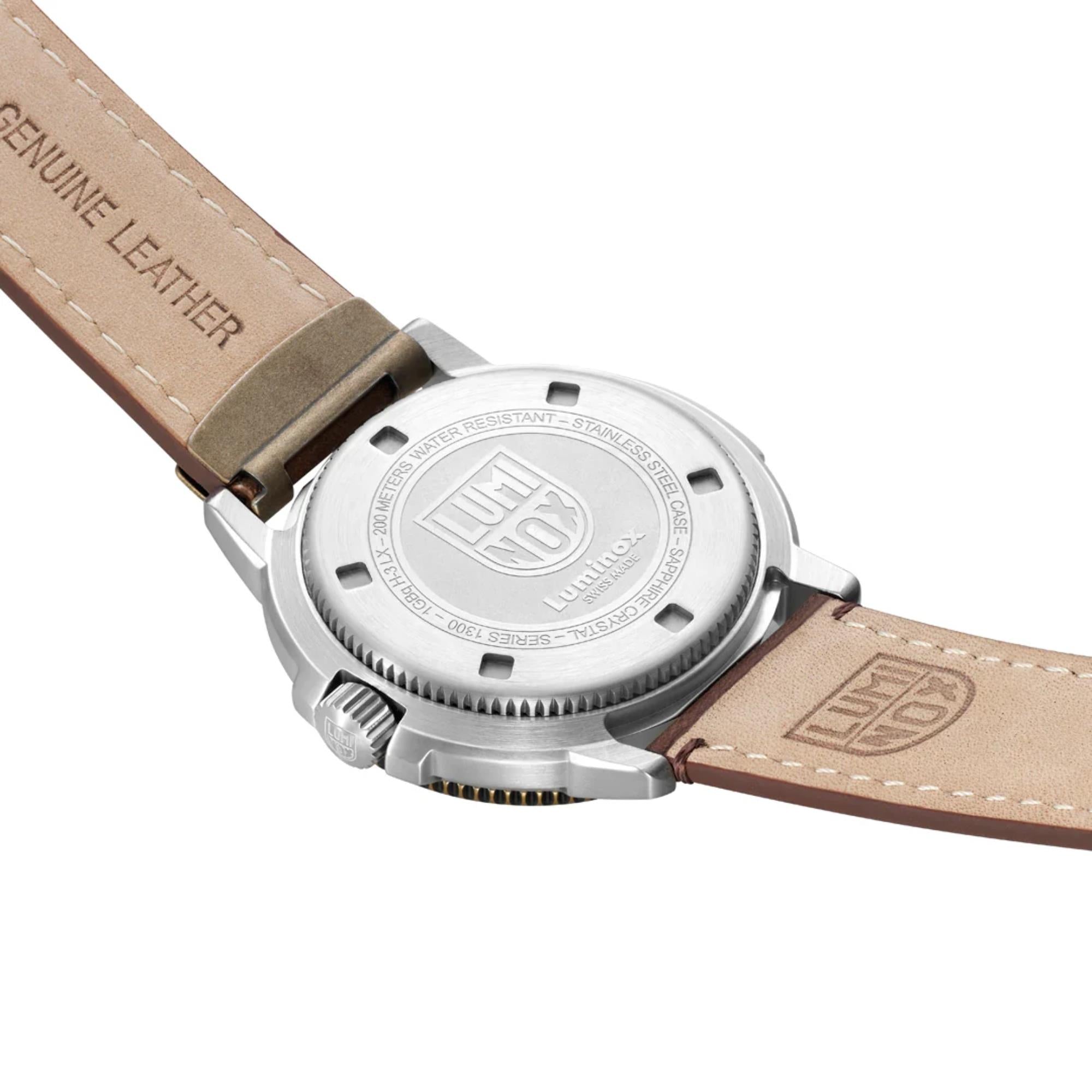 Angled view of the engraved stainless steel caseback of the Luminox Adventure Watch XL.1301.LG and the tan underside of the leather strap stamped with "Genuine Leather"