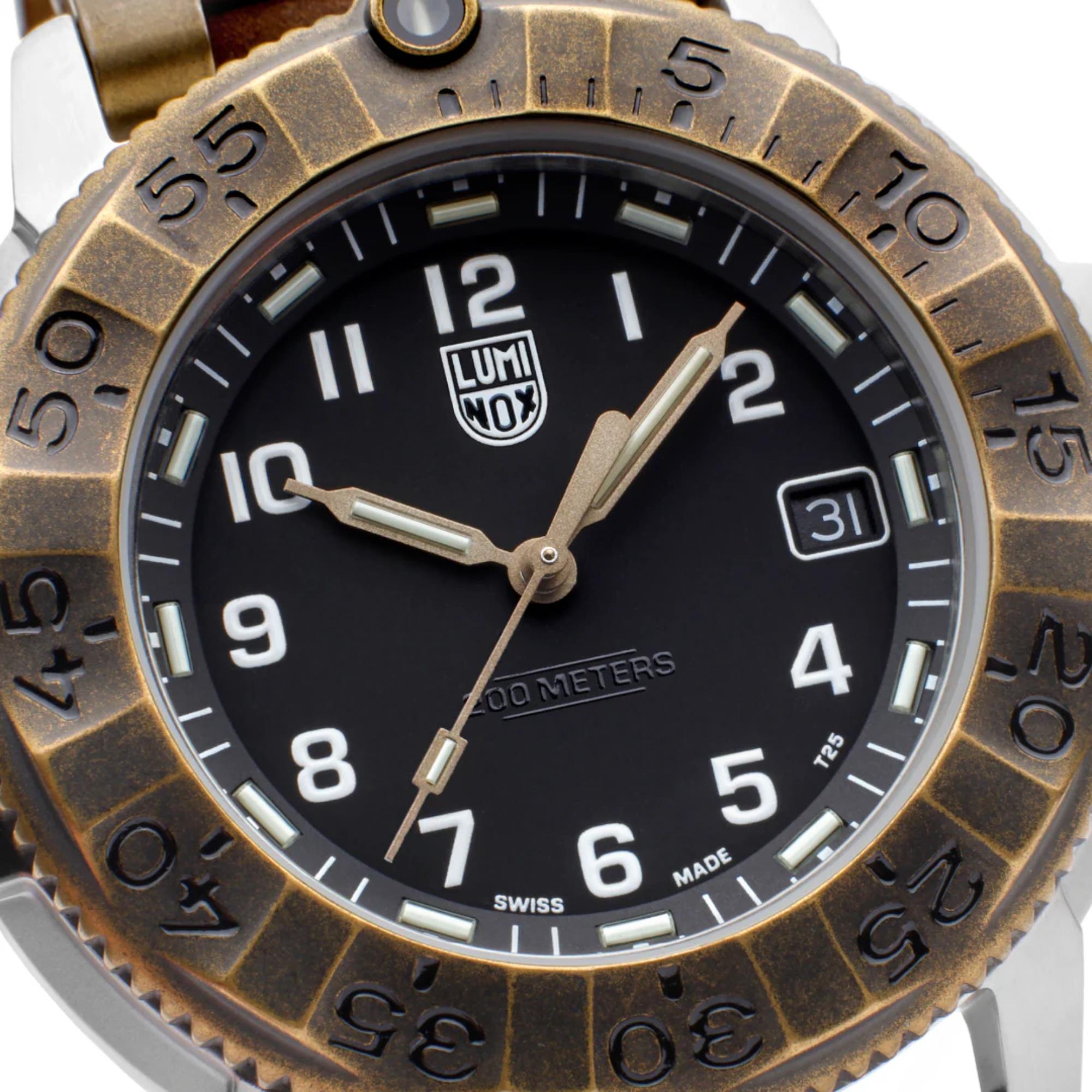 Close-up of the Luminox Adventure Watch XL.1301.LG black dial, showing the textured bronze bezel, white numerals, luminescent hands, and a date window at 3 o'clock