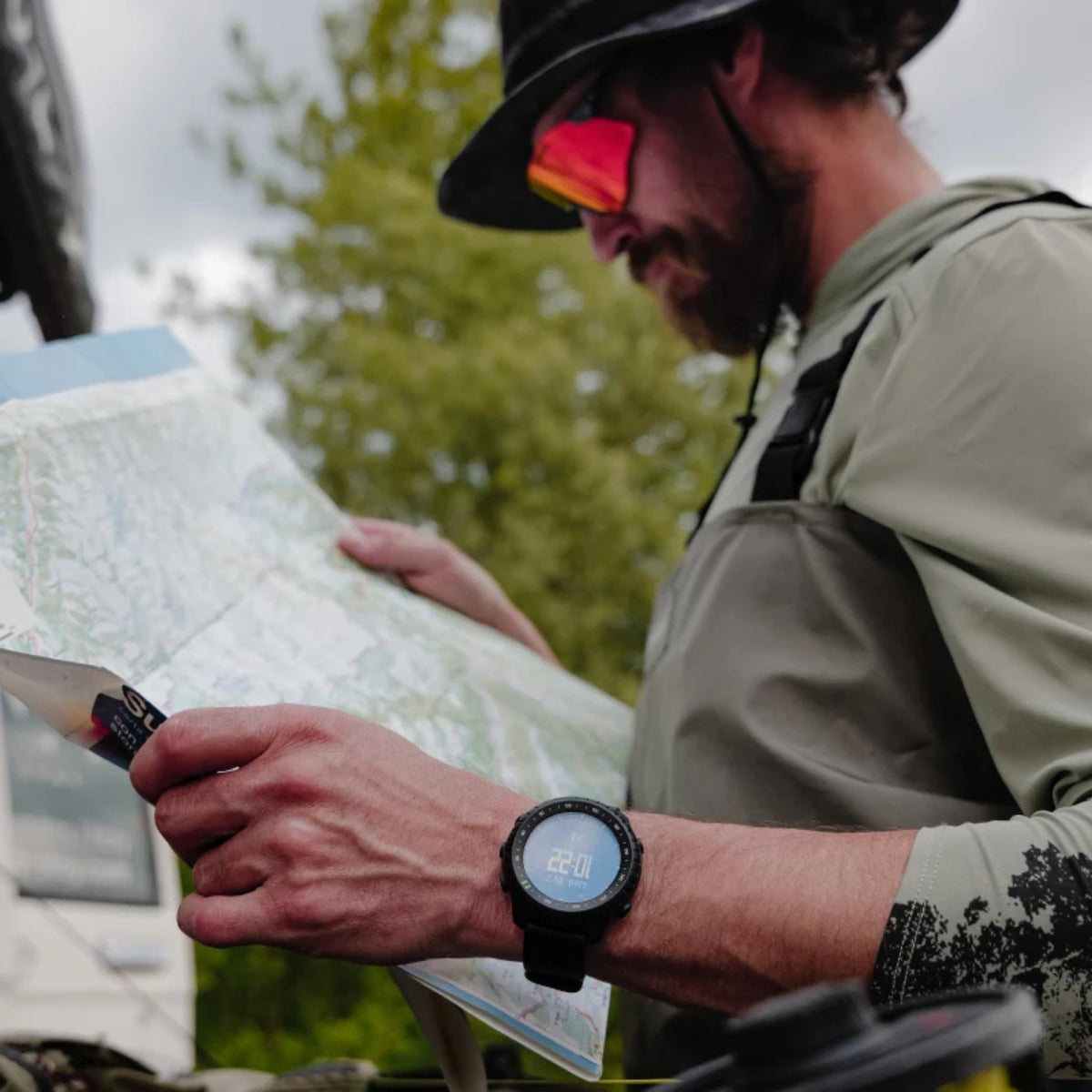 Suunto Core SS051780000 on-wrist view while holding map during outdoor navigation