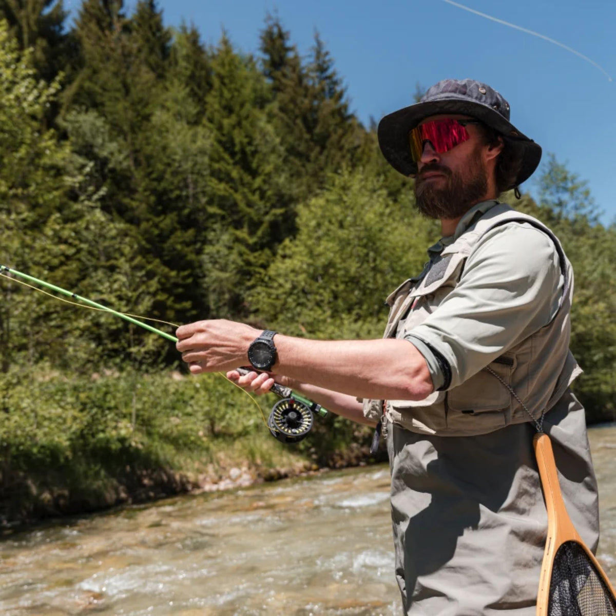 Suunto Core SS051780000 lifestyle shot worn during fly fishing activity outdoors