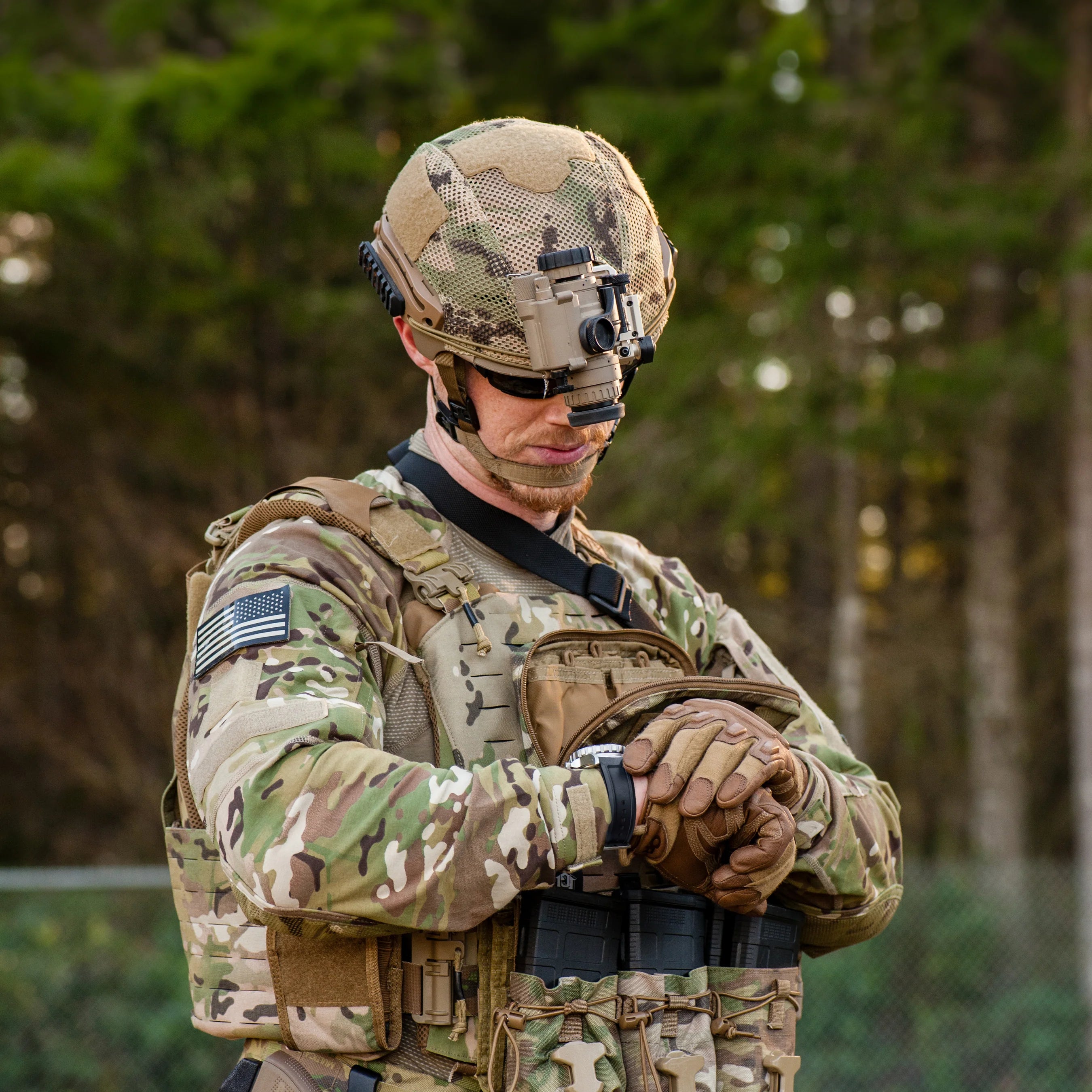 Marathon Military Watch worn on the wrist of a soldier in full camouflage combat gear with a helmet and night vision equipment