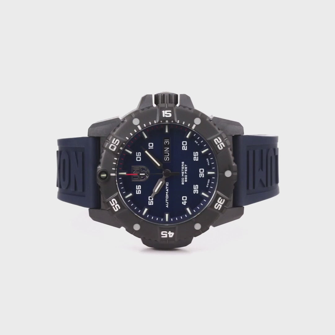 Luminox Master Carbon SEAL XS.3863 automatic timepiece overhead view highlighting the blue dial, black rotating bezel, and matching blue rubber strap